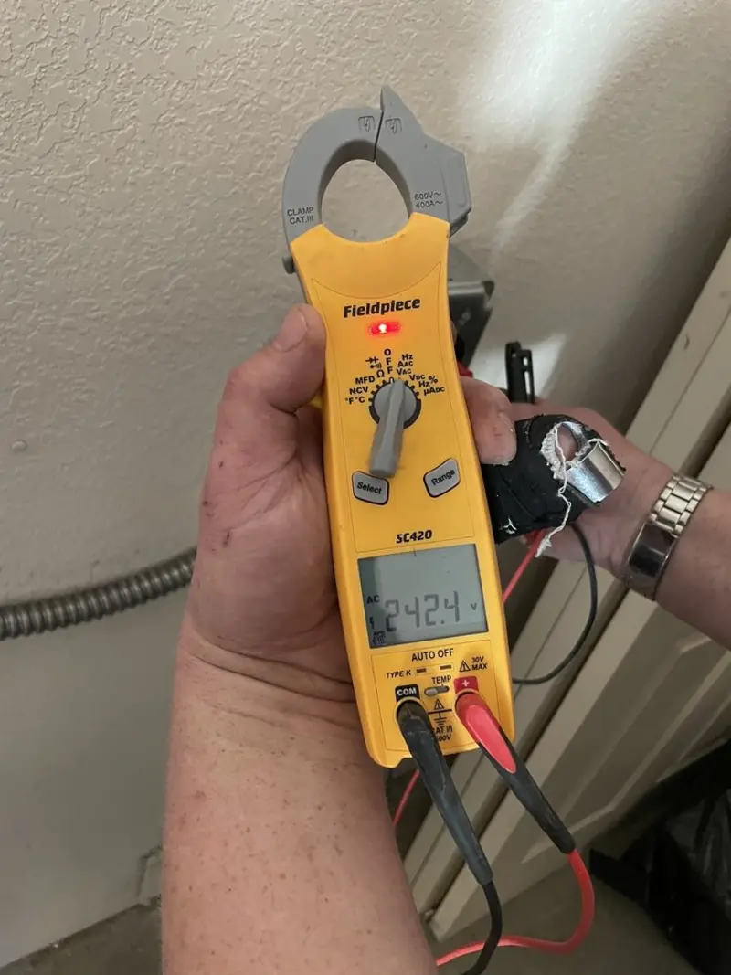Voltage testing with clamp meter during Ceiling Fan Installation in Simonton Lake